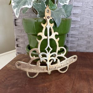 May include: A rustic wooden sign with the text "Welcome to our home" in white lettering. The sign features a distressed finish and a simple, inviting design, perfect for front door decor.