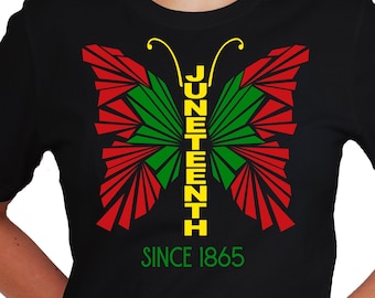 May include: Black t-shirt with a red, green, and yellow butterfly design. The butterfly has the word "Juneteenth" written vertically down the center. The text "Since 1865" is printed below the butterfly.