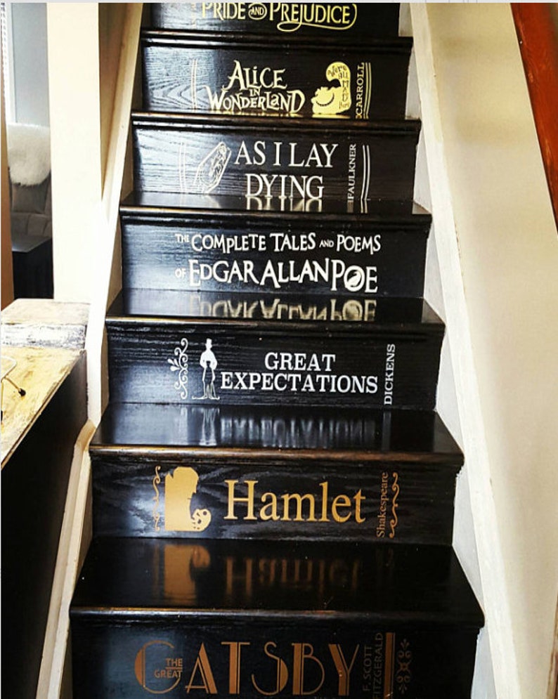 May include: Black wooden staircase with book titles painted on each step. Titles include "Pride and Prejudice," "Alice in Wonderland," "As I Lay Dying," "The Complete Tales and Poems of Edgar Allan Poe," "Great Expectations," "Hamlet," and "The Great Gatsby."