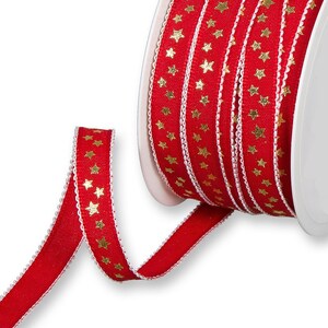May include: Red ribbon with gold stars. The ribbon is wound around a spool.