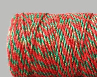 May include: A roll of red and green twine with gold accents. The twine is perfect for wrapping gifts or adding a festive touch to crafts.