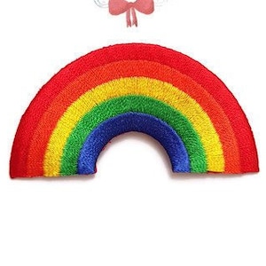 May include: Rainbow-coloured embroidered iron-on patch in the shape of a rainbow arch. The patch is perfect for adding a touch of whimsy to clothing, bags, or other fabric items.