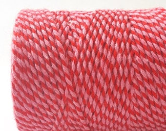 May include: A roll of red and pink baker's twine. The twine is twisted together to create a striped pattern.