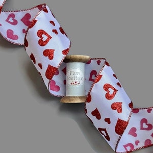 Red Glitter Hearts on White Ribbon with Red Wired Edge, 63mm (2.5in) wide *Sold Per Metre*