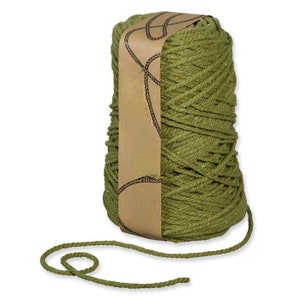 May include: A large spool of green cotton rope with a brown paper label. The label has a rope design and the words "The Rope Company" printed on it.