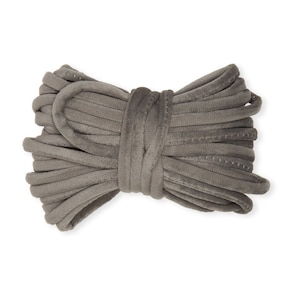 May include: A grey velvet cord, folded in a bow shape, is ready for crafting projects.
