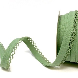 May include: A roll of sage green elastic trim with a delicate crochet edge. The trim is approximately 1 inch wide.