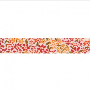 May include: A white ribbon with a floral pattern in shades of orange, red, and yellow. The flowers are small and scattered across the ribbon.