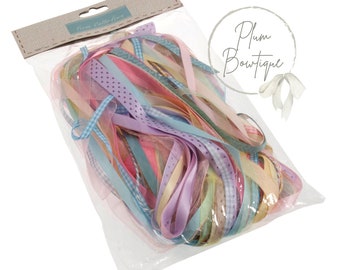 May include: A clear plastic bag filled with a variety of colorful ribbons. The ribbons are in shades of pink, blue, yellow, and green. Some of the ribbons have a polka dot pattern, while others have a checkered pattern. The bag is labeled "Trim Collection" and "Plum Boutique".