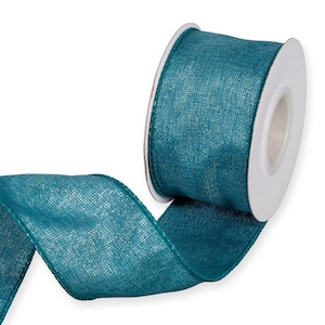 May include: A roll of teal ribbon with a textured, woven appearance. The ribbon is unwound, showing its width and texture. The spool is white, and the ribbon is a solid, rich teal colour.