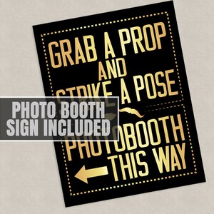 May include: Black and gold photo booth sign with the text "Grab a prop and strike a pose" and an arrow pointing to the right with the text "Photo booth this way".