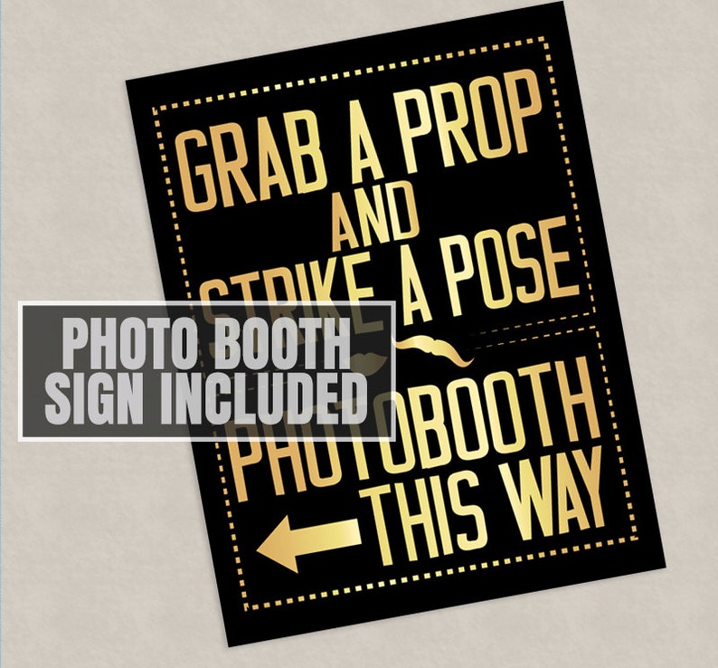 May include: Black and gold photo booth sign with the text "Grab a prop and strike a pose" and an arrow pointing to the right with the text "Photo booth this way".