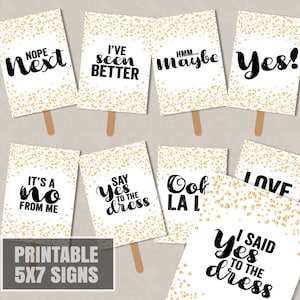 May include: Printable 5x7 signs with gold glitter background and black text. The signs feature phrases like "Nope Next", "I've Seen Better", "Say Yes to the Dress", and "I Said Yes to the Dress".