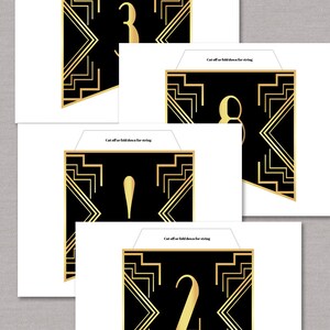 May include: Four printable black and gold Art Deco style banners with the numbers 1, 2, 3, and 4. The text "Cut off or fold down for string" is printed on each banner.