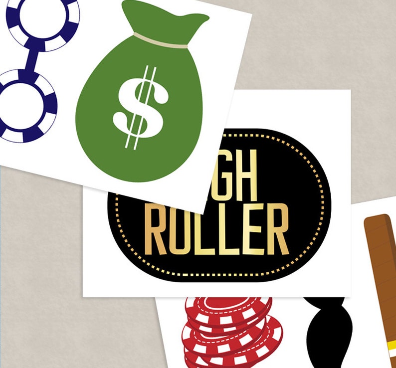 May include: A set of four printable casino party decorations. The decorations include a green money bag with a dollar sign, a black and gold circle with the text "High Roller", a stack of red and white poker chips, and two blue poker chips connected by a chain.