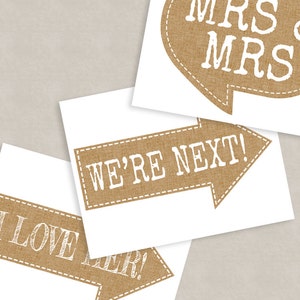 May include: Three printable signs with a burlap texture and white text. The signs say "We're Next!" "I Love Her!" and "Mrs & Mrs".