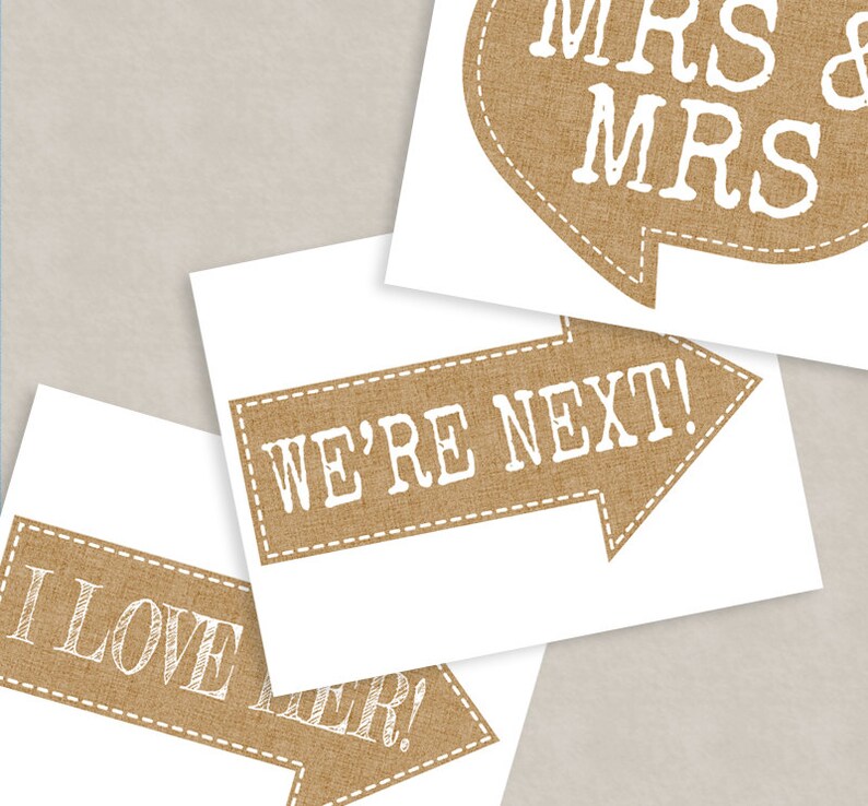 May include: Three printable signs with a burlap texture and white text. The signs say "We're Next!" "I Love Her!" and "Mrs & Mrs".