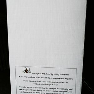 May include: A white card with a black and white illustration of a dog's head in a heart shape. The text on the card reads "Lounge in the Sun" by Holly Simental. Available in giclee print and cards at mamakikis.etsy.com. Other items such as cups, pillows, etc available at society6.com/hollysimental. Proverbs 31:25 "She is clothed in strength and dignity and she laughs without fear of the future. When she speaks, her words are wise, and she gives instructions with kindness."  ♡ Holly Smith