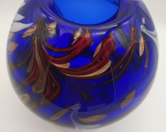 Large, mouth-blown glass vase in cobalt blue with copper aventurine, white and red glass swirls.