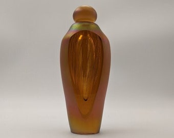 Signed, dated, Brian Maytum mouth blown, studio art glass perfume bottle with iridescent gold finish & facets revealing interior. 5.25"