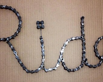 Chained to the Ride (Bicycle Chain upcycled into the word "Ride")