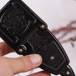 May include: Black plastic electrical outlet adapter with the text "ЭЛЕКТРИК УТЮГ" in Cyrillic script. The adapter has a triangular logo with the text "СССР" and a star.