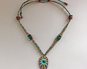 Beautiful ceramic sunburst focal piece on a micro macrame necklace