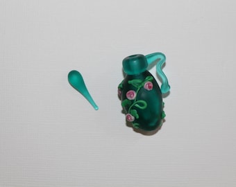 Deep teal with accents of pink flowers and green leaves on this beautiful lampwork piece