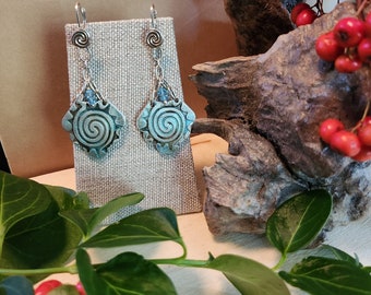 Which do you see.....the curl of a rising wave or the swirl rays of the sun on these earrings?