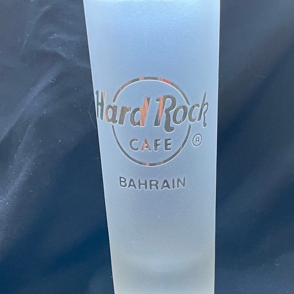 One Hard Rock Café Bahrain frosted white gold tone engraved double shot glass. Used display only. Vintage collectible.