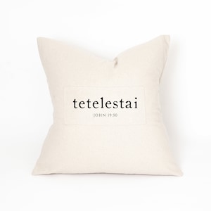 May include: A white pillow with the text "tetelestai" and "JOHN 19:30" printed on it.