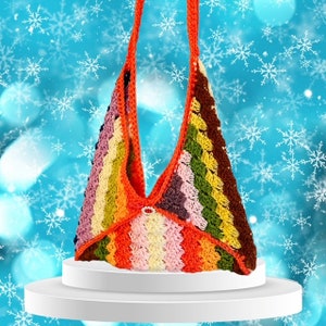 May include: A colorful crocheted shoulder bag with a rainbow stripe pattern. The bag has a single strap and a button closure.