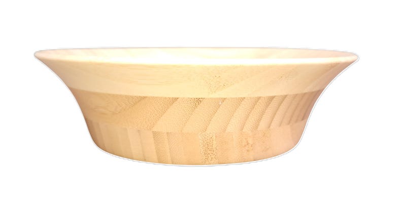 Puede incluir: Un cuenco de madera de color claro con un dise&ntilde;o amplio y acampanado. El cuenco tiene un borde liso de color claro y una secci&oacute;n inferior texturizada de color claro. El cuenco se utiliza probablemente para servir alimentos o como objeto decorativo.