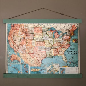 May include: A vintage map of the United States with state borders and names labelled in a colourful, stylised font. The map includes Alaska and Hawaii, and the text "Bacon's Standard Map of the United States" is printed in the lower right corner.