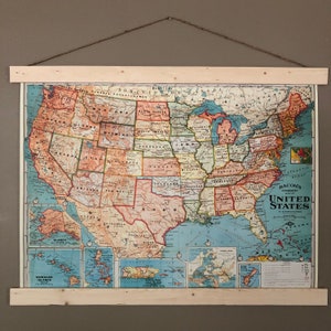 May include: A vintage map of the United States with state borders and names labelled in a colourful, stylised font. The map includes Alaska and Hawaii, and the text "Bacon's Standard United States" is printed in the bottom right corner.
