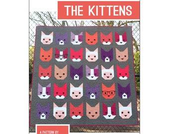 May include: A 66" x 66" quilt titled THE KITTENS by Elizabeth Hartman. The quilt features a grid of thirty cat faces in various colors and patterns, including two cats wearing black glasses, set against a dark gray background with a red border.