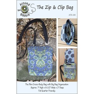 May include: A blue cross-body bag with a floral pattern, black strap, and the text "The Zip & Clip Bag." The bag is approximately 7 inches high, 6.5 inches wide, and 2 inches deep. Includes additional images of the bag's interior and a matching accessory.