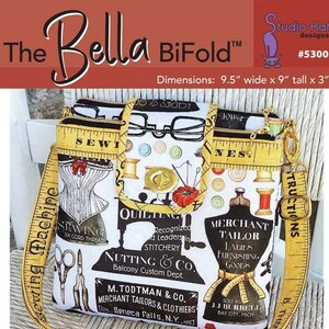 May include: A sewing-themed bifold wallet with a yellow measuring tape strap. The wallet is 9.5 inches wide, 9 inches tall, and 3 inches deep. It features two separate zippered storage pouches, a built-in dropdown wallet area, and a secure twist-lock closure.