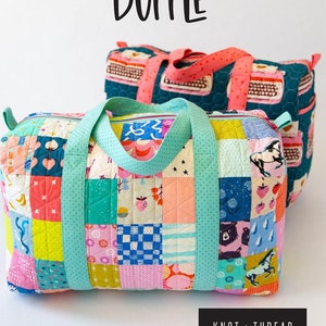 May include: Two patchwork duffle bags with colorful, quilted designs. One bag features a vibrant mix of squares with various patterns and a light blue handle. The other bag is teal with a typewriter pattern and a pink handle. Text reads "PATCHWORK DUFFLE".