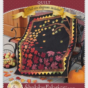 May include: A quilt titled Autumn Allure Quilt with full-size diagrams included. The quilt features a black background with a brown tree trunk and colorful maple leaves in shades of red, orange, yellow, and green, with a sawtooth border.