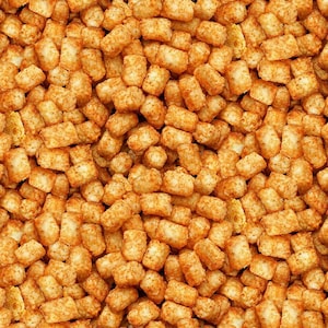 May include: A large collection of golden-brown, cylindrical potato tots arranged in a dense, uniform pattern. Each individual piece features a textured, crispy exterior with visible potato shreds, creating a consistent, repetitive food surface.