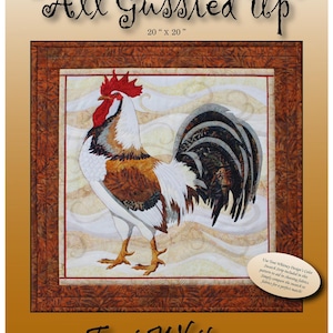 May include: A quilt pattern titled "All Gussied Up" featuring a rooster design. The rooster is depicted in shades of white, brown, red, and black. The pattern measures 20 x 20 inches.