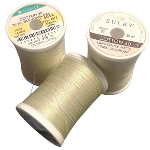 May include: Three spools of Sulky Cotton 30 thread in a pale, shimmering yellow-green hue. Each spool features white plastic ends with printed labels detailing specifications like 30 wt., 500 yds, 450m, and 100% cotton composition.