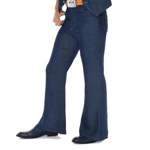 May include: Dark blue denim bell-bottom jeans. The jeans have a classic five-pocket design and a flared leg from the knee down. The jeans are paired with dark blue leather shoes.