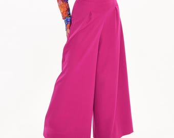 May include: Wide-leg pants in a vibrant fuchsia pink color. The pants have a high waist and a pleated front.