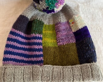 Hand knit purple blue green and grey hat with removable pom