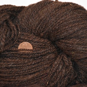 Hand spun dark brown sport weight yarn. Handspun wool yarn in a rich natural color brown.
