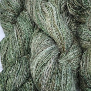 Handspun longwool and locks yarn in a gray base with greens and browns
