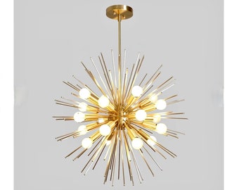May include: A gold-toned, modern chandelier with a spherical shape and multiple light bulbs. The chandelier has a starburst design with thin, pointed arms extending outward from the center.