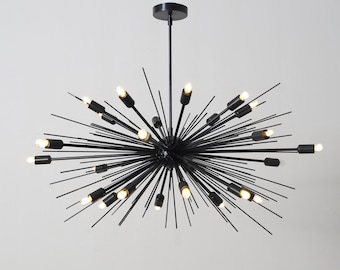 May include: Black metal chandelier with multiple arms extending outward, creating a starburst design. Each arm has a small light bulb at the end.